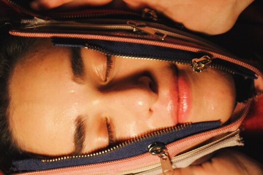 closeup portrait of woman being unzipped through zips *2