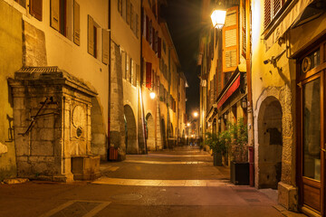 Fototapeta na wymiar A street in the evening with lights, in the evening, in Annecy, Haute-Savoie, France