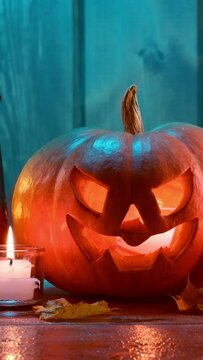 jack-o-lantern candles, lantern and leaves in dramatic lighting, halloween design concept.