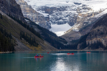 Beautiful landscape, Red Small Boats on Lake Louise, White Snow Mountain in Banff National Park, Canada
