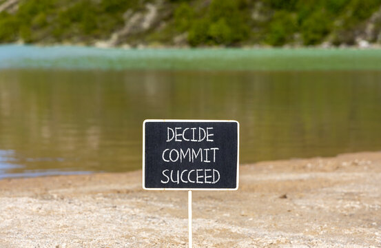Decide commit succeed symbol. Concept word Decide Commit Succeed on beautiful black chalk blackboard. Beautiful mountain lake sand beach background. Business decide commit succeed concept. Copy space.