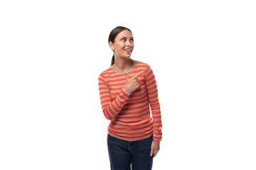 a young caucasian woman with black hair dressed in a striped orange jacket gesticulates with her hands, attracting attention