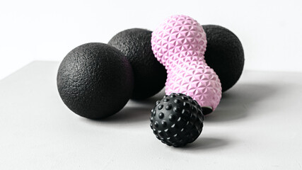 Rubber foam pink peanut roller, black massage ball. Yoga, fitness equipment. Centimeter tape for measuring waist volume. Stretching, pilates accessories. Home workout sport exercises for weight loss - Powered by Adobe