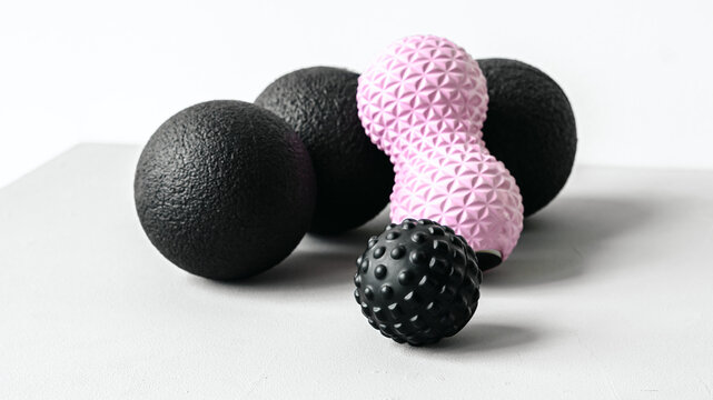 Rubber foam pink peanut roller, black massage ball. Yoga, fitness equipment. Centimeter tape for measuring waist volume. Stretching, pilates accessories. Home workout sport exercises for weight loss