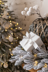 Fototapeta na wymiar White gift box in Christmas decor. Lights and Christmas tree.