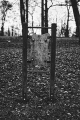 black and white photo of detail of playground during winter season