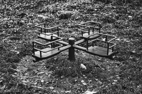 black and white photo of detail of playground during winter season