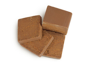 Brown cheese. Norwegian brunost isolated on white background. Top view. Flat lay