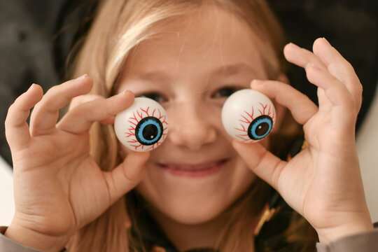 A girl fooling around with capillary eyes on Halloween