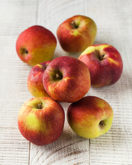 Ripe juicy apples on a light wooden background. Fruit, harvesting.