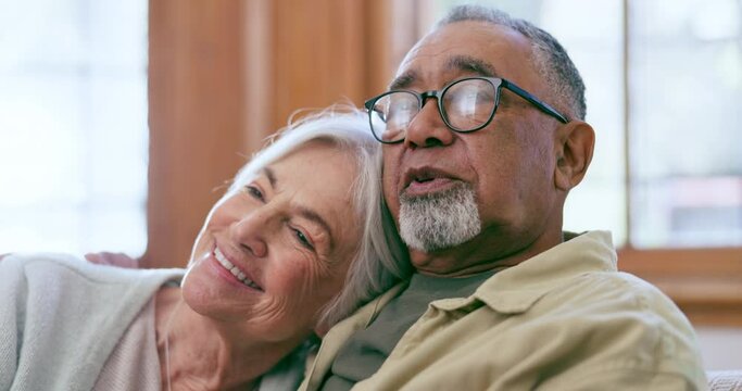 Talking, watching tv and senior couple in home, relax and happy together in retirement. Television, smile and elderly man and woman laugh at comedy movie, funny show or film for interracial people