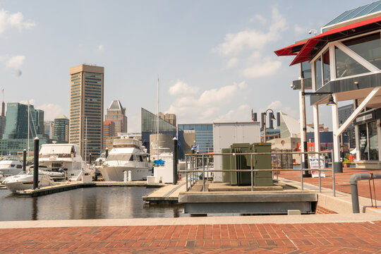 Baltimore, Maryland, US - July 26, 2023: Exterior of waterfront promenade at the inner harbor marina docks adjacent to The Rusty Scupper Restaurant