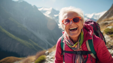 happy smiling elderly senior woman hiking in the mountains