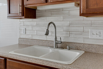 Clean Apartment Kitchen Faucet with Sink and DIY Backsplash with Wood Cabinets