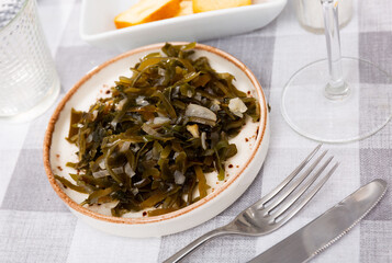 Traditional Japanese cuisine dish of spicy pickled oarweeds with onions served as snack..