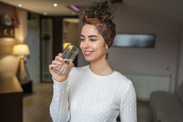portrait of woman young caucasian female drink glass of water at home