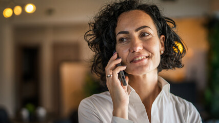 One woman mature caucasian female businesswoman entrepreneur stand at work or home use mobile phone...
