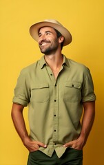 A man in cowboy hat with a yellow background with free space for text.