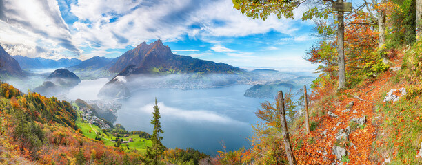 Fabulous autumn view of Stansstad city and Lucerne lake with mountaines and fog.