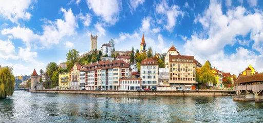Papier Peint photo Ciel bleu Fabulous historic city center of Lucerne with famous buildings and calm waters of Reuss river.
