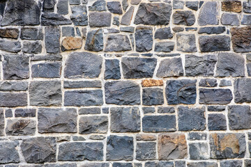 a chunky brick wall made from big blocks of stone