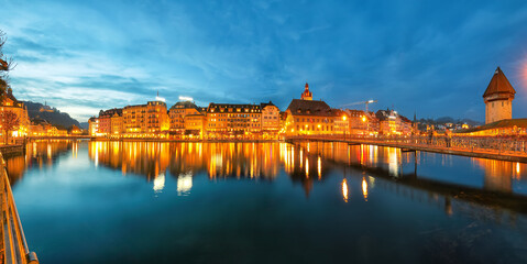 Beautiful historic city center of Lucerne with famous buildings and promanade during night..