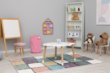 Child`s playroom with different toys and modern furniture. Stylish kindergarten interior