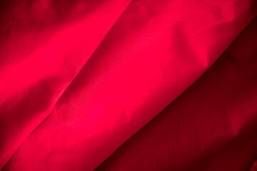 Red cotton background. Abstract on fabric light shadow effect in background.