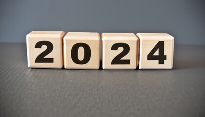 2024 text on wooden cubes, new year concept on gray background