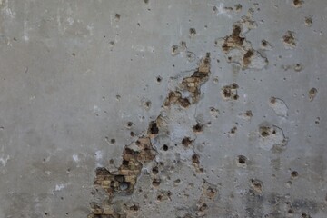 Bullet and mortar holes damage the building facade 