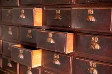 Gordijnen Vintage background of old wooden drawers pattern texture. Old wooden textured drawers background in chinese or thai herbal medicine shop. Vintage asian objects. © Koonsiri
