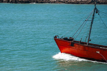 Bow of a Trawler fishing vessel, raising sea foam as it sails, leaving the Port of Mar del Plata, Argentina.