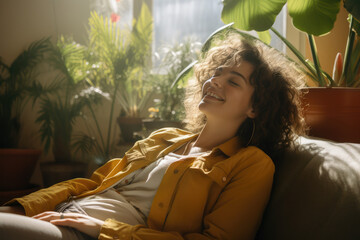 woman in dress relaxing on the couch with plants - obrazy, fototapety, plakaty