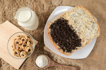 Bread with chocolate cookies oreo cheese and butter spread on a plate for breakfast