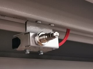 Image of limit switch attached to metal cabinet door to detect mechanical movement and actuators...