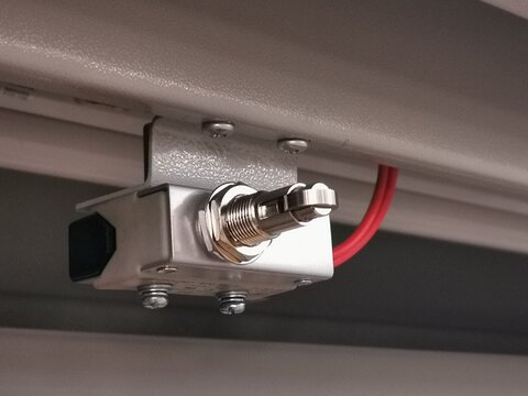 Image of limit switch attached to metal cabinet door to detect mechanical movement and actuators limits.