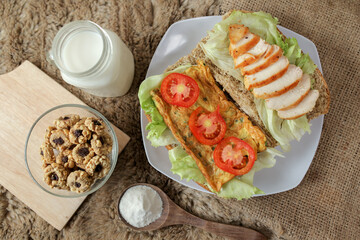 Big breakfast, bread, chicken slice, tomato, lettuce, smoked beef, egg, salad with milk. Bread sandwich fresh and healthy food meal lunch dinner breakfast slices of sandwiches.