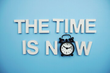 The Time is Now alphabet letters on blue background
