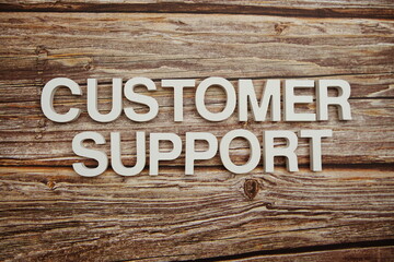 Customer Support alphabet letters on wooden background