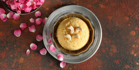 Bowl with traditional Indian food pongal on grunge background, top view