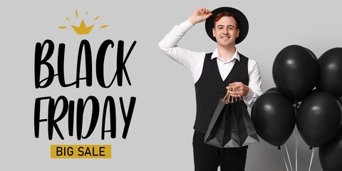 Young man with shopping bags, balloons and text BLACK FRIDAY BIG SALE on grey background