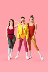 Obraz premium Portrait of sporty young women on pink background