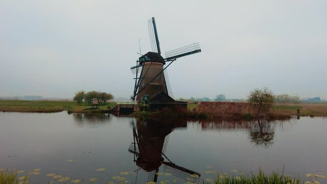 dolly towards famous Dutch old-fashioned windmill in Kinderdijk the Netherlands