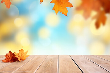 Naklejka na ściany i meble Wooden table with autumn leaves on bokeh light blue, white and yellow background. High quality photo