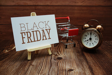 Black Friday text on paper card on wooden background