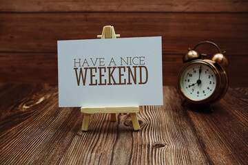 Have a nice weekend text on paper card on wooden background - obrazy, fototapety, plakaty