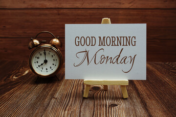 Good Morning Monday text on paper card on wooden background