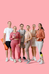 Obraz premium Group of sporty young people with equipment on pink background
