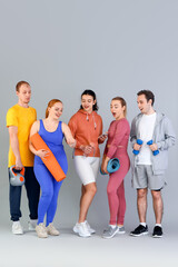 Fototapeta premium Group of sporty young people with equipment on grey background