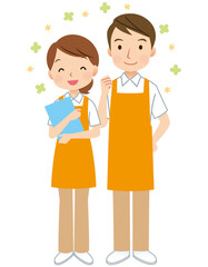 エプロンをつけた男女　介護士　ヘルパー